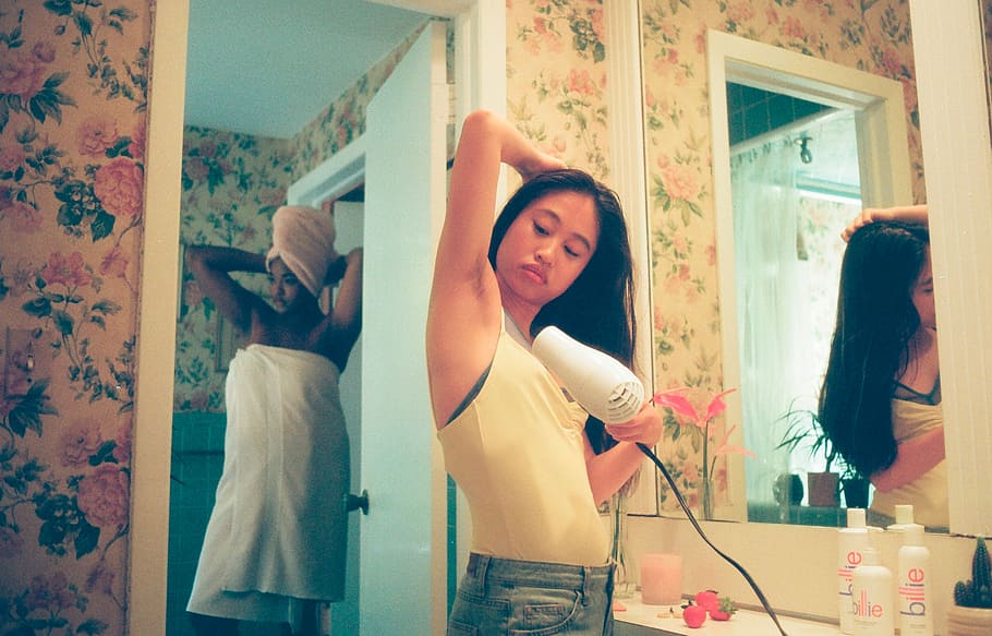 woman wearing white tank top, woman blow drying its armpit inside bathroom HD wallpaper