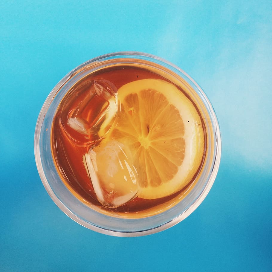 beverage with lemon, sliced orange juice in clear drinking glass