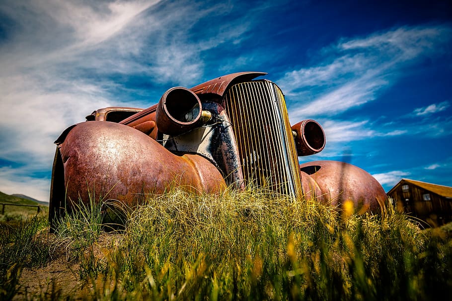 rusted vintage brown car under cloudy sky during daytime, scrap