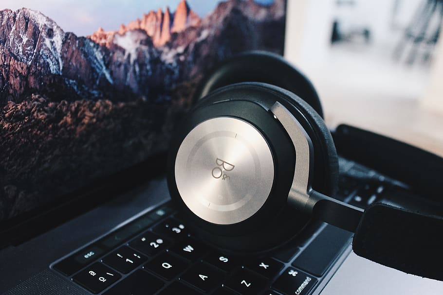 black and gray wireless headphones, silver and black headphones on laptop HD wallpaper
