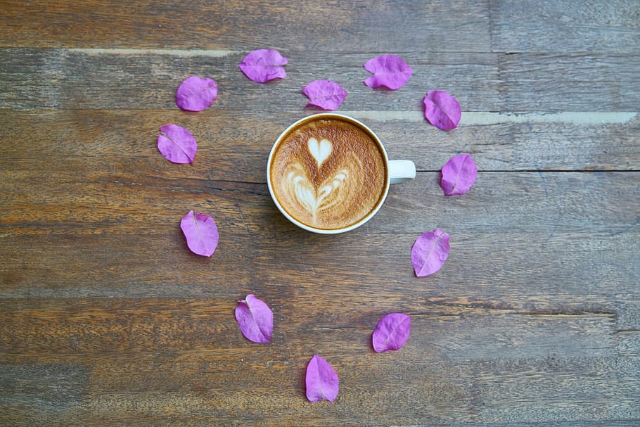 white ceramic teacup filled with coffee surrounded with pink flower petals HD wallpaper