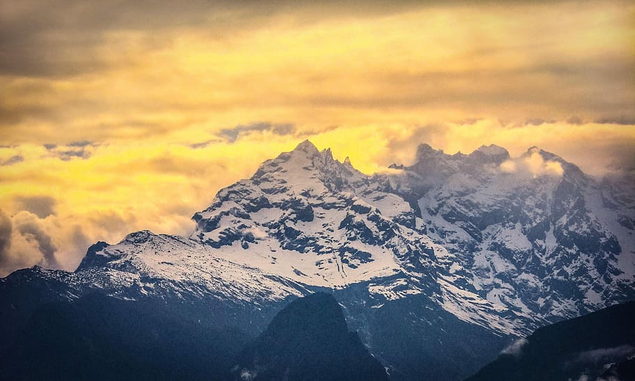 snow-capped mountain during golden hour aerial photo, landscape photography of mountains surrounded by clouds HD wallpaper
