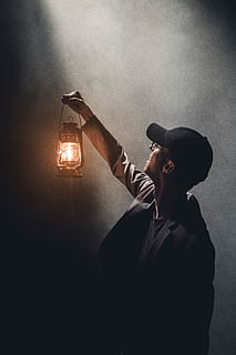 man holding lighted gas lantern, man holding up a lantern, lamp HD wallpaper
