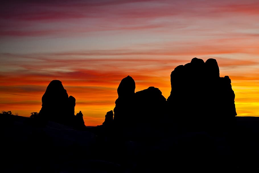 Silhouettes of Rock Formation during Sunset, backlit, clouds HD wallpaper