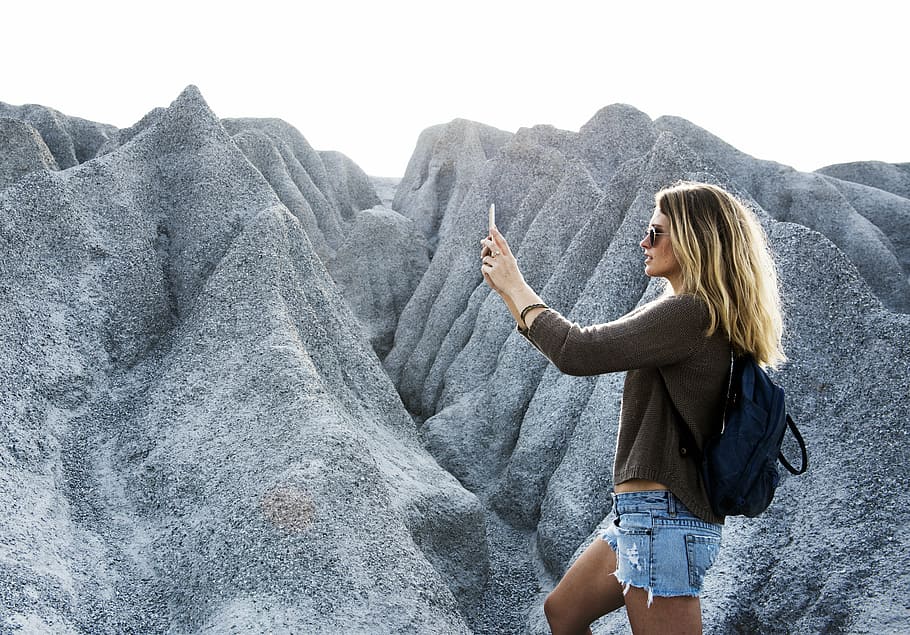 woman standing near mountain raneg, phone, technology, dom, rock