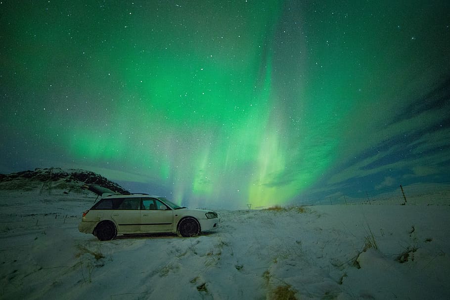 white station wagon during northern lights, green, aurora, borealis