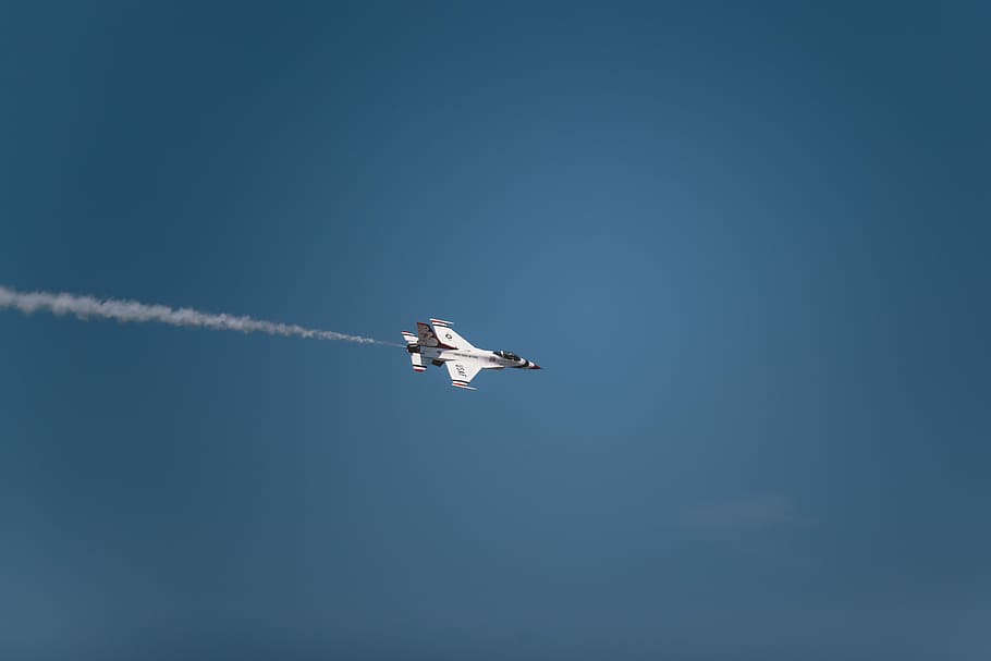 white jetplane with white smoke trails, white fighter jet flying in the sky