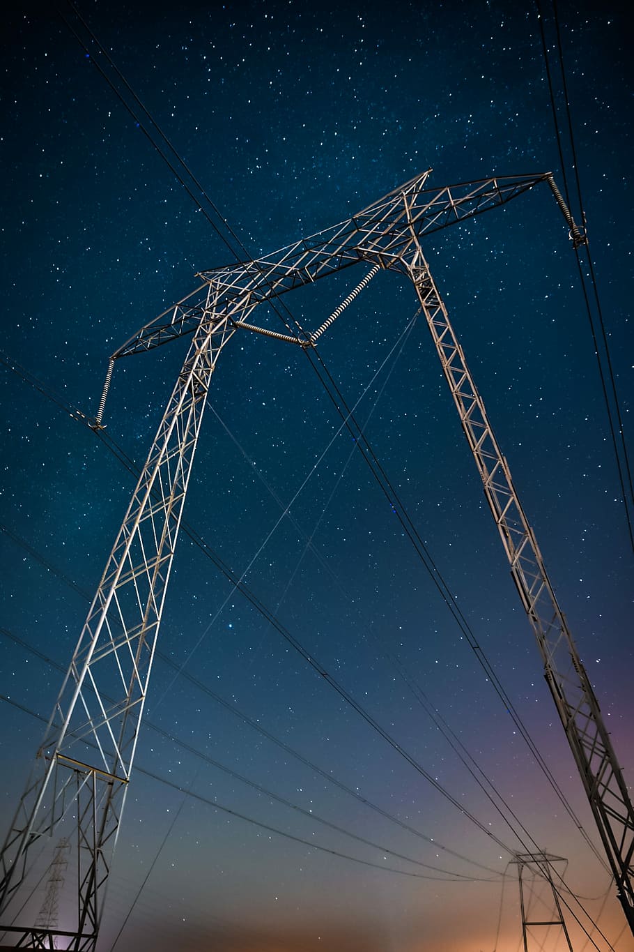 low angle photography of transmitter tower, low-angle photography of electric post during starry night