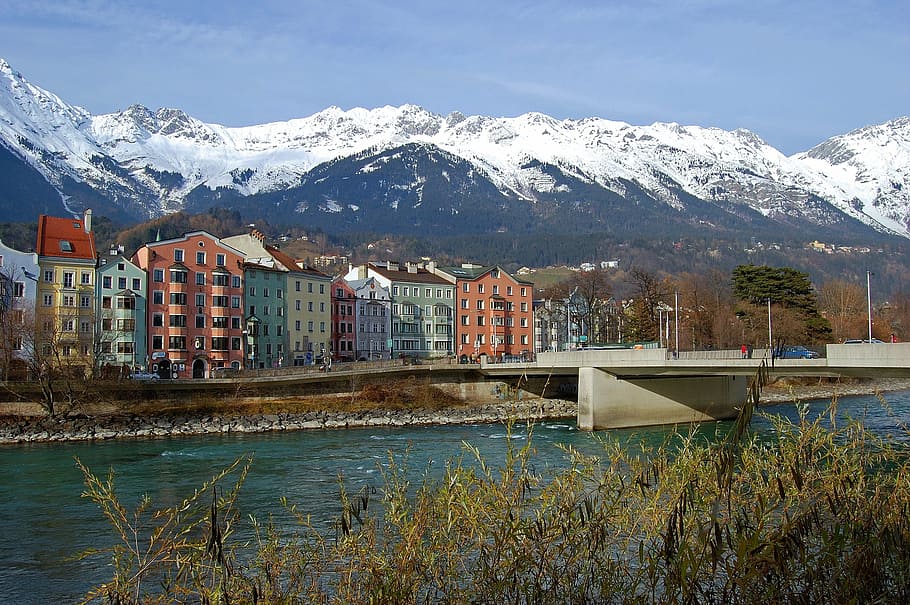 Premium Photo | Panorama view of colorful buildings and mountains across  from flowing river of innsbruck austria