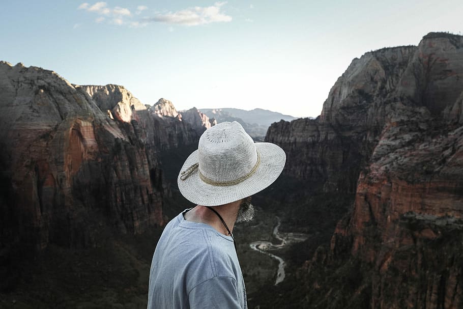person looking on rock mountain during daytime, man looking at canyon HD wallpaper