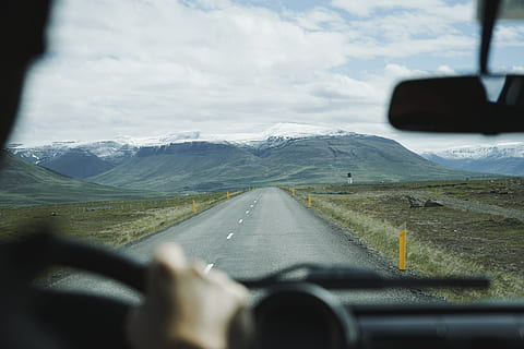 person driving, man driving on black concrete road beside green grass field at daytime HD wallpaper