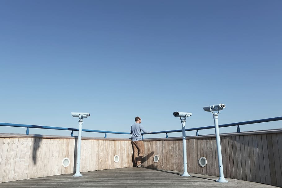 man standing outdoors facing backwards, person, corner, rail HD wallpaper