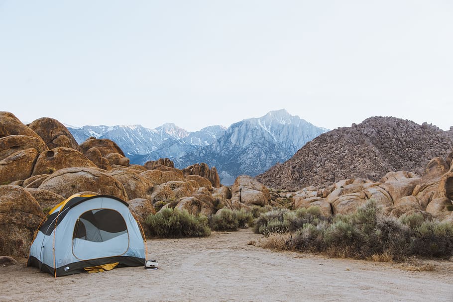 white and black dome tent setted up beside brown boulders overlooking mountain under white sky, white and black dome tent HD wallpaper
