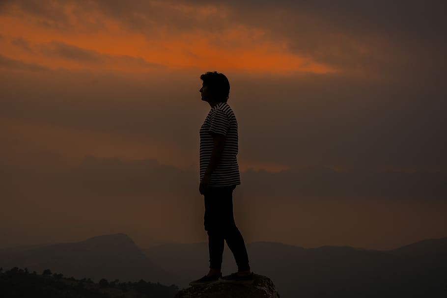 person wearing white and black striped shirt standing on cliff HD wallpaper