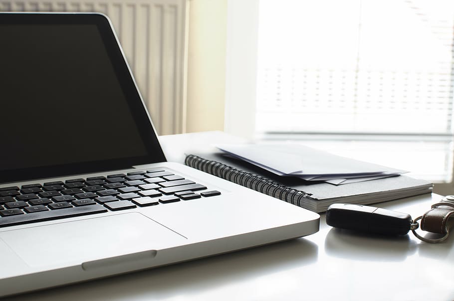 powered-off MacBook Pro beside notebook, busy, home, desk, paper, HD wallpaper