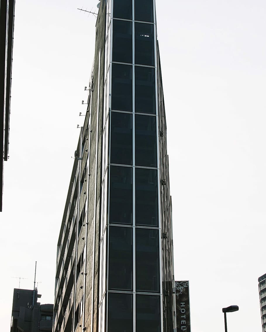 gray and black high-rise building, tall glass b uilding, corner HD wallpaper