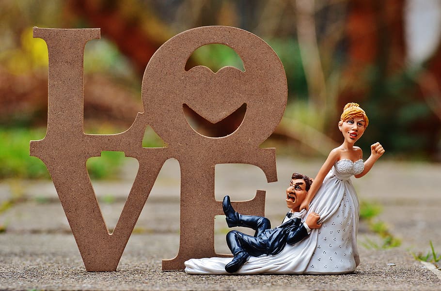 male and female couple figurine on concrete surface, grind down the aisle