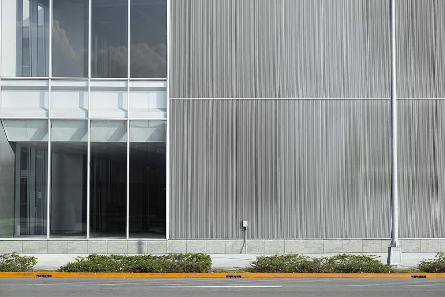 gray and white concrete building at daytime, front view of gray and white building beside empty roadway HD wallpaper