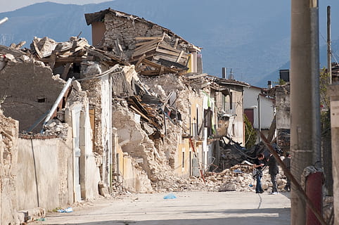 three people standing near wrecked building during daytime HD wallpaper