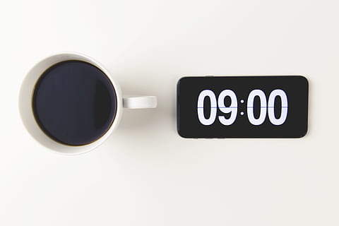 Cup of coffee with the time displayed on mobile iPhone smartphone clock HD wallpaper