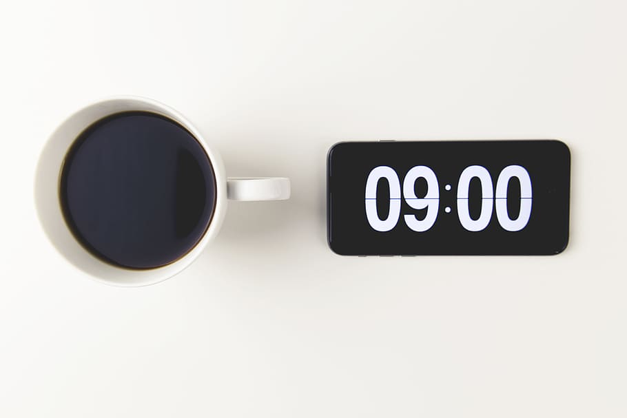 Cup of coffee with the time displayed on mobile iPhone smartphone clock HD wallpaper