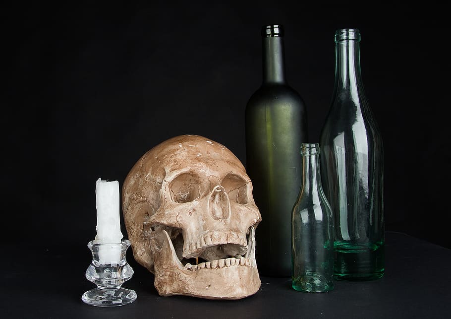 brown skull, white candle and three glass bottles, the bottle HD wallpaper