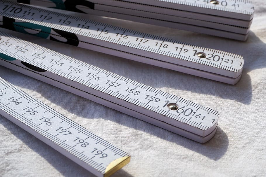 selective focus photography of gray rulers on white textile HD wallpaper