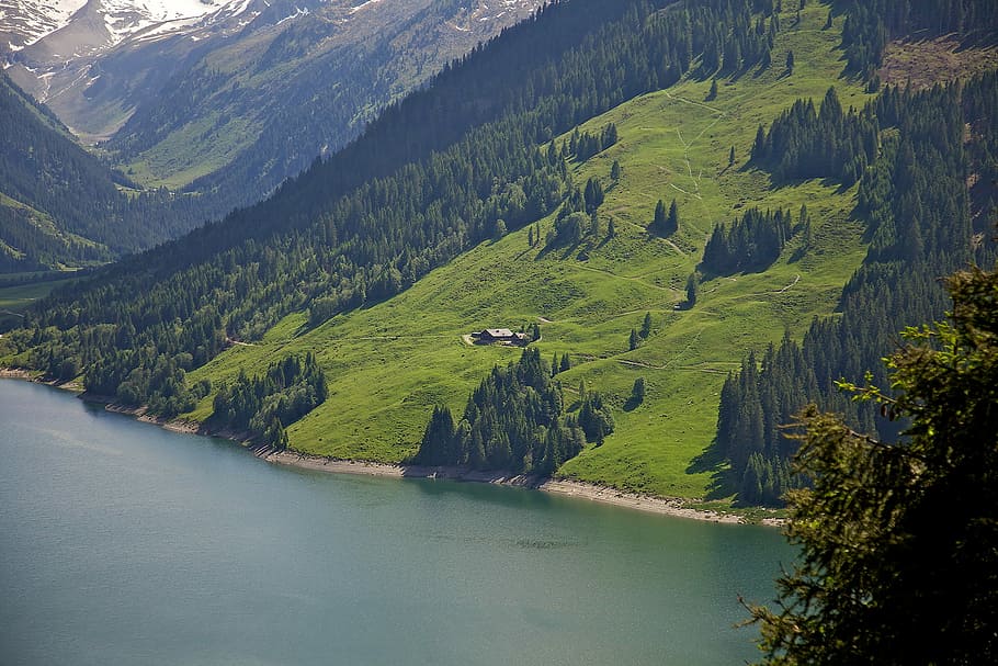 aerial photography of green grass field near body of water, landscape photo of green grass covered mountain during daytime HD wallpaper