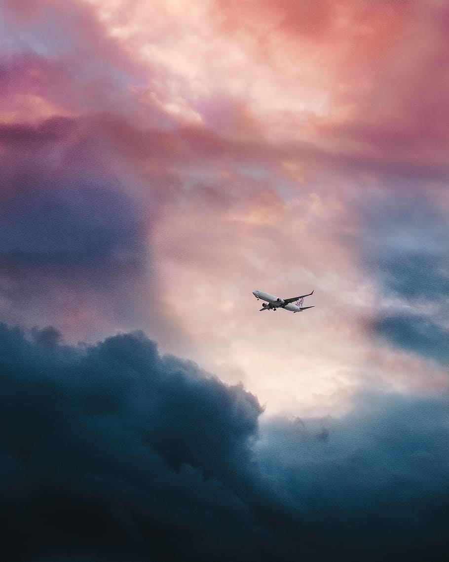 white plane flying over gray clouds, low angle view of airplane HD wallpaper