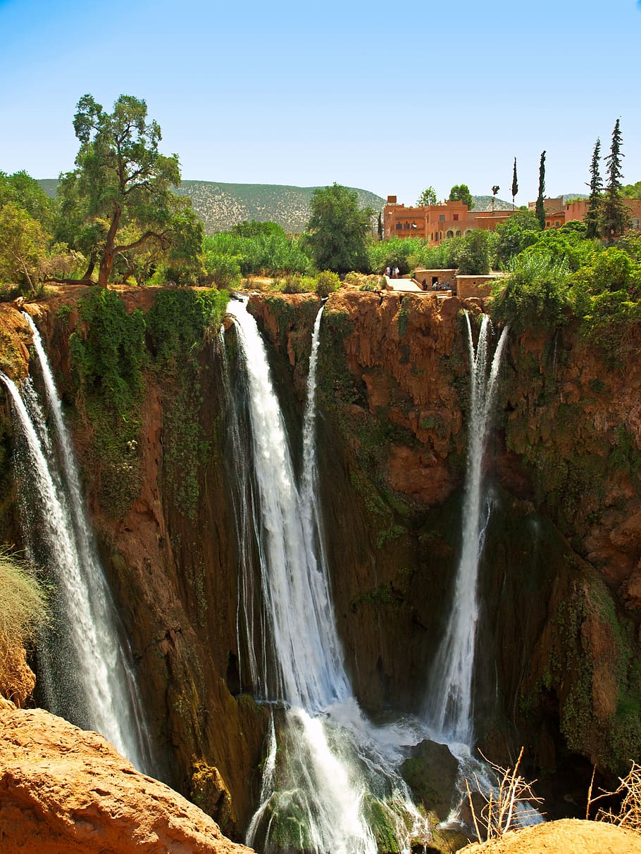 waterfalls near concrete building at daytime, ouzoud, morocco HD wallpaper