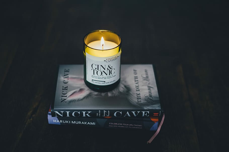 Candle on pile of books, lighted candle on book, stack, table HD wallpaper