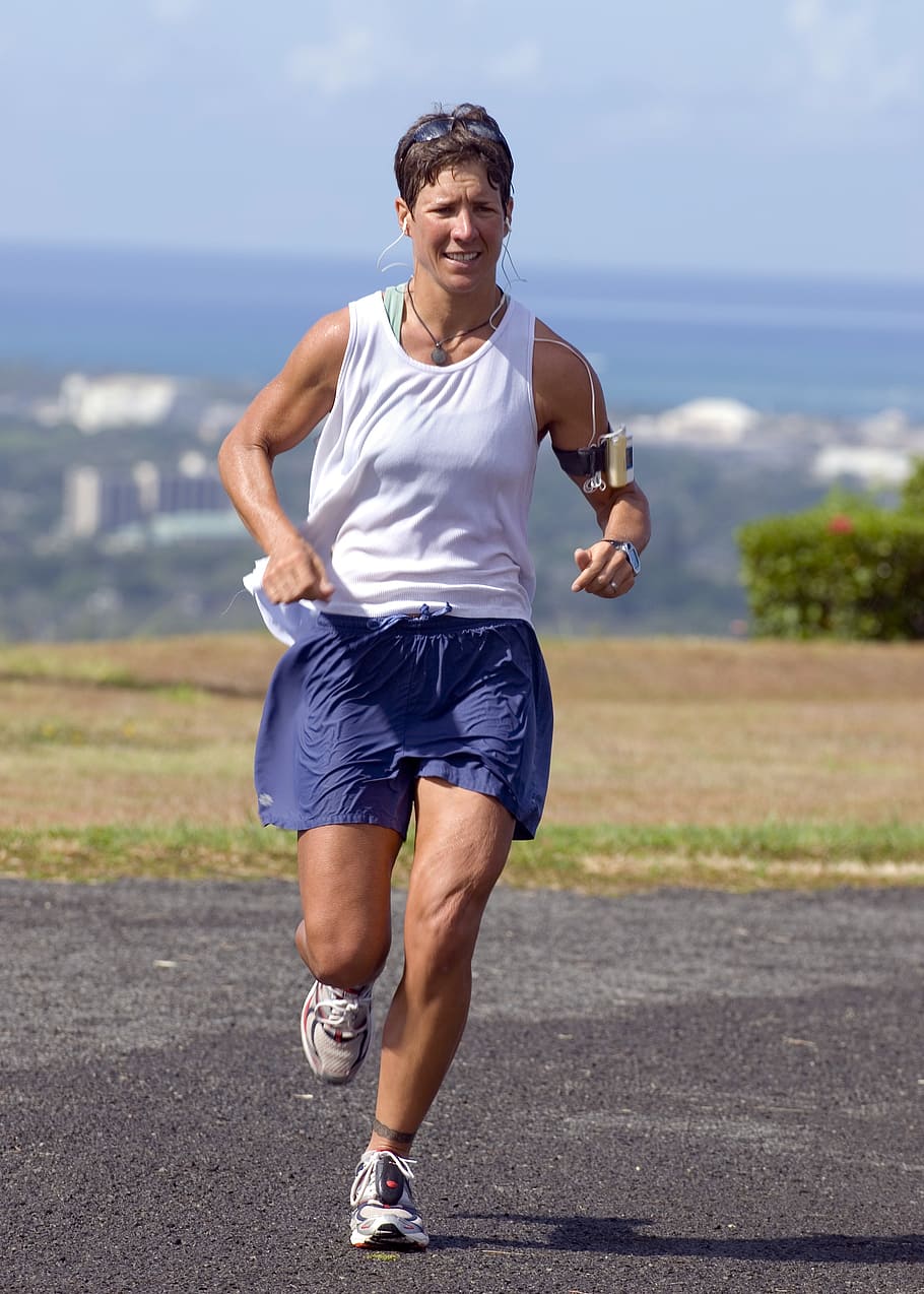 woman running on concrete road during daytime, runner, training