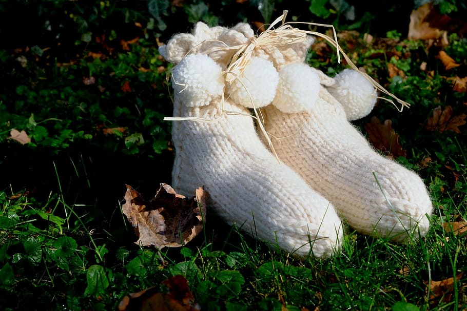 pair of white knitted shoes in green grass, socks, warm, wool HD wallpaper