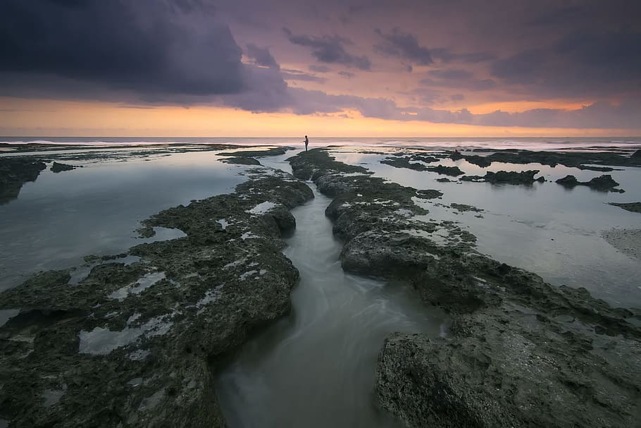 Body of Water Under Grey and Orange Sky during Daytime, beach HD wallpaper