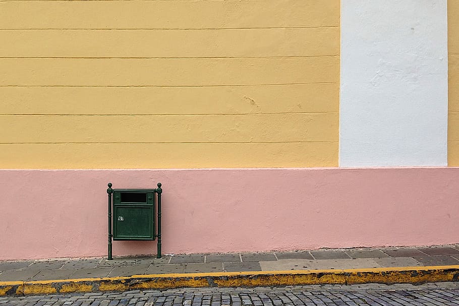 green mailbox beside the pink wall, green wooden trash cabinet on wall stret HD wallpaper