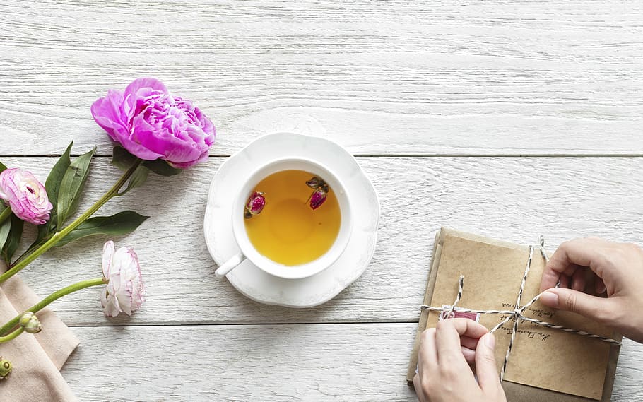 white teacup filled with yellow liquid on white saucer, flower HD wallpaper