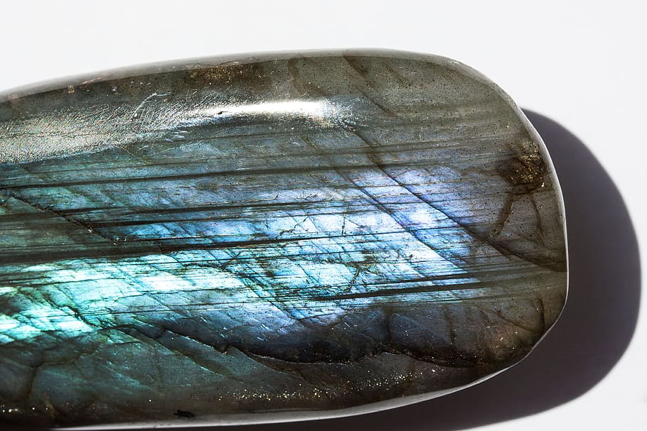 gray, brown and blue stone fragment, gem, labradorite, ground