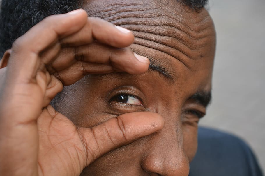 man touching his eye with two fingers, somalia, face, facial expression HD wallpaper