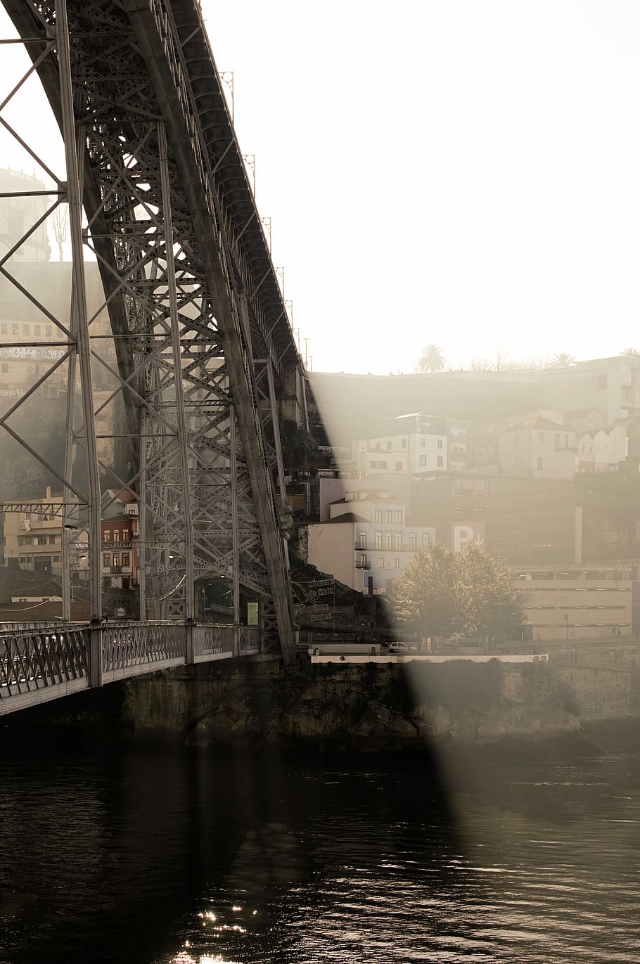 white steel bridge under white sky during daytime, grey metal bridge overlooking concrete buildings at daytime HD wallpaper