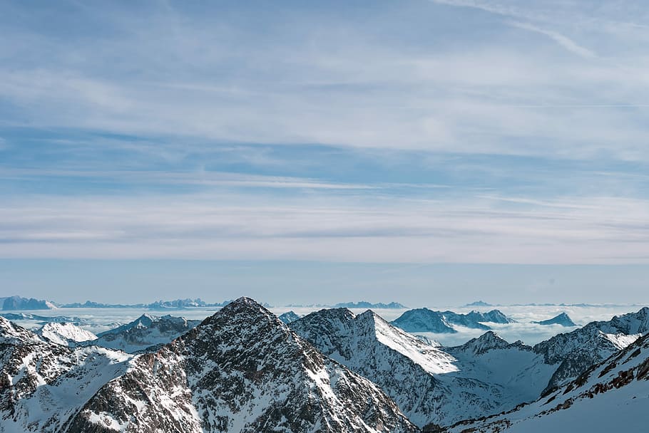 ice capped mountain under cumulus clouds at daytime, aerial view of snowy peak mountains HD wallpaper