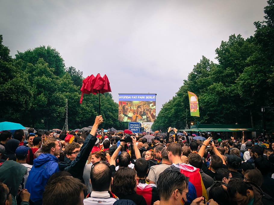 crowded street with man raising his red umbrella, people, gathering HD wallpaper