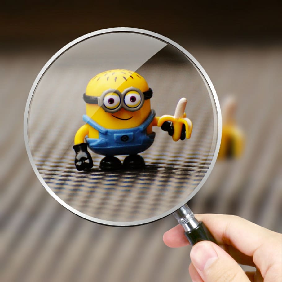 Despicable Me character holding banana figurine, minion, funny