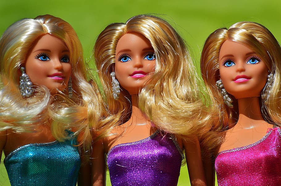close-up photography of three barbie doll wearing dress, beauty