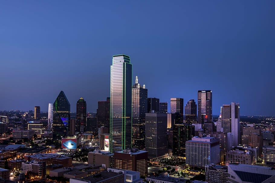 high-rise buildings under blue and gray sky at nighttime, dallas