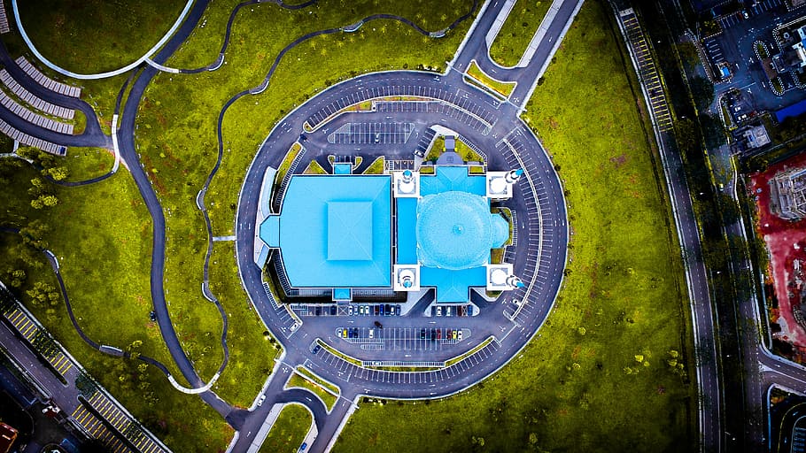 aerial view of blue concrete building, aerial photography of blue building near green grass