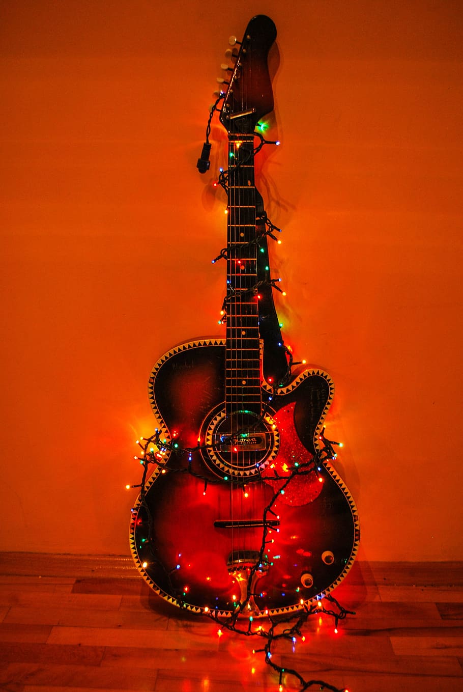 HD wallpaper: acoustic guitar surrounded with string lights against the  wall | Wallpaper Flare