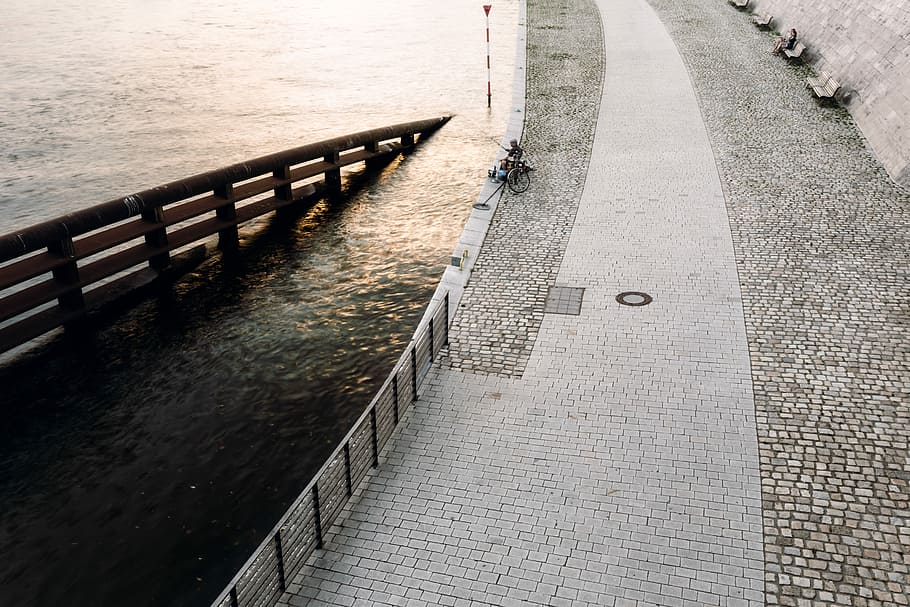 high angle photo of man fishing near the bridge, architectural photography of bricked road HD wallpaper