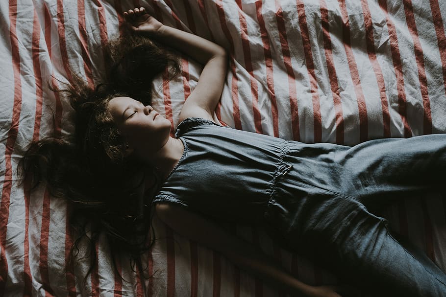 woman wearing gray sleeveless jumpsuit lying on bed, resting HD wallpaper