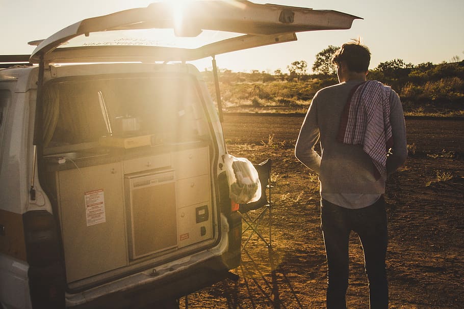 man standing near white van during daytime, man standing near open rear door vehicle HD wallpaper
