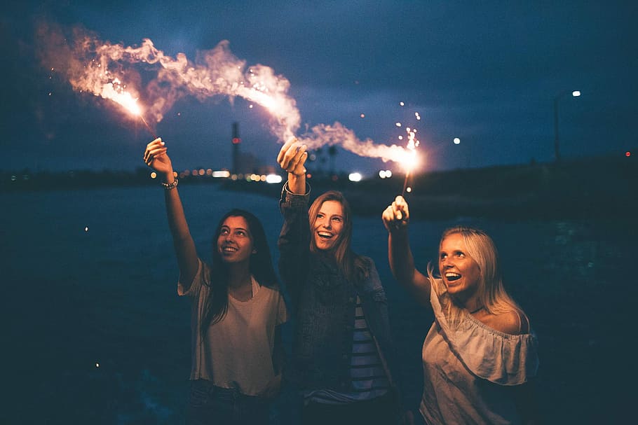 aly, callah, & mckailee, two women raising lighted sparklers HD wallpaper